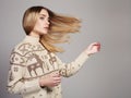 Beautiful Woman with flying hair in winter pullover. Beauty Blond Girl Royalty Free Stock Photo