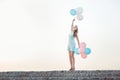 beautiful woman with flying multicolored balloons Royalty Free Stock Photo