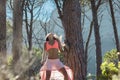 Woman dancing in a forest flicking her hair with trees in the background. Royalty Free Stock Photo