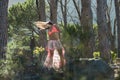 Woman dancing in a forest flicking her hair with trees in the background. Royalty Free Stock Photo