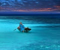 Beautiful woman in the fragile boat in a stormy sea Royalty Free Stock Photo