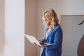 A beautiful woman freelancer, blogger, influencer with a laptop in her hands works remotely. Soft selective focus