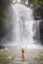 A beautiful woman in front of Tegenungan waterfall in bali Royalty Free Stock Photo