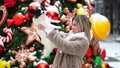 Beautiful woman with dog Papillon near the Christmas tree on the street.dog peed