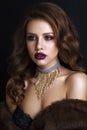 Beautiful woman in fur cout with evening makeup and hairstyle Royalty Free Stock Photo