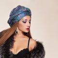 Beautiful woman in fur,jewelry and turban