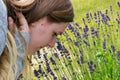 Beautiful woman in the garden smelling flowers. Girl smelling a bouquet of lavender on a hot summer day. aged Royalty Free Stock Photo