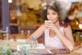 Beautiful woman gazing out a coffee window daydreaming Royalty Free Stock Photo