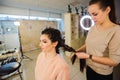 Beautiful woman getting haircut by hairdresser in the beauty salon Royalty Free Stock Photo