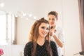 Beautiful woman getting haircut by hairdresser in the beauty salon. Royalty Free Stock Photo