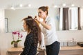 Beautiful woman getting haircut by hairdresser in the beauty salon. Royalty Free Stock Photo