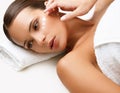 Beautiful Woman Getting Spa Treatment. Cosmetic Cream on a Cheek Royalty Free Stock Photo