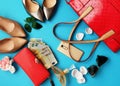 Business Woman Accessories Red Wallet with money euro Red handbag  perfume black Sunglass And Silver Shoes on High Heels on Blue Royalty Free Stock Photo