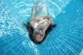 Beautiful woman girl dress underwater diving swim blue sunny day pool Royalty Free Stock Photo