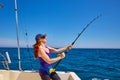 Beautiful woman girl fishing rod trolling in boat