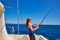 Beautiful woman girl fishing rod trolling in boat Royalty Free Stock Photo