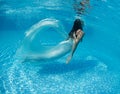 Beautiful woman girl white dress underwater diving swim blue sunny day pool Royalty Free Stock Photo