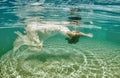 Beautiful woman girl white dress underwater diving swim blue sunny day pool Royalty Free Stock Photo