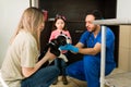 Beautiful woman giving her dog to the professional vet