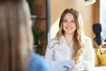 Beautiful woman giving interview in modern microphone.