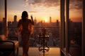 Beautiful woman with glass of champagne standing on a balcony at sunset, Rich woman rear view enjoy the sunset standing on the