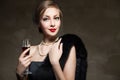 Beautiful woman with glass red wine. Retro style Royalty Free Stock Photo