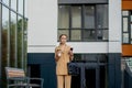 Beautiful Woman Going To Work With Coffee Walking Near Office Building. Portrait Of Successful Business Woman Holding Cup Of Hot Royalty Free Stock Photo