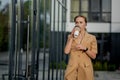 Beautiful Woman Going To Work With Coffee Walking Near Office Building. Portrait Of Successful Business Woman Holding Cup Of Hot Royalty Free Stock Photo