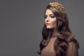 Beautiful woman in gold crown on her head. Royalty Free Stock Photo