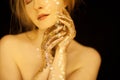 Beautiful woman in gold, golden hands, glitter sensual glamour luxury Royalty Free Stock Photo
