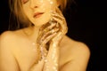 Beautiful woman in gold, golden hands, glitter sensual glamour luxury