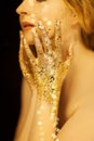 Beautiful woman in gold, golden hands, glitter sensual glamour luxury Royalty Free Stock Photo