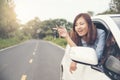 Beautiful woman got new car. showing car key from window out of new car Royalty Free Stock Photo