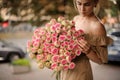 beautiful woman with great bouquet of roses in her hands Royalty Free Stock Photo