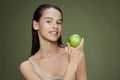 beautiful woman green apple near face health  background Royalty Free Stock Photo