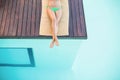 Beautiful woman in green bikini relaxing by poolside Royalty Free Stock Photo