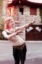 Woman in green costume for trible dancing with outstrechd hands and looking away Royalty Free Stock Photo