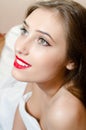 Beautiful woman with green eyes red lips looking up smiling in bed Royalty Free Stock Photo