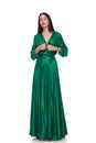 Beautiful woman in green long dress standing with eyes closed