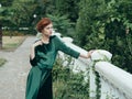 Beautiful woman in green luxury dress glamor of nature walk green leaves Royalty Free Stock Photo