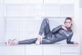 Beautiful woman in grey fashion latex suit with stripes on white background