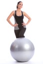 Beautiful woman in gym with fitness exercise ball