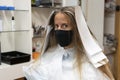 Beautiful woman in hairdressing salon ,with hair dye paper or aluminum foil before change the hair color,wearing medical Royalty Free Stock Photo