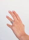 Woman hand with Bold Adjustable Silver Ring set against a white background