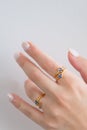 Beautiful woman hand and fingers wearing rings set against white. Beautiful valentine`s gifts Royalty Free Stock Photo