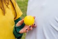 A beautiful woman hand holds a yellow sphere Royalty Free Stock Photo