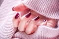 Red Wine Elegance: Manicured Nails and Woolen Scarf