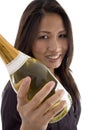 Beautiful woman handling Champagne bottle