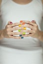 Beautiful woman hands with colorful rainbow nail polish