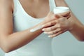 Beautiful woman hands with cream. Closeup woman applying protective cream on hand.